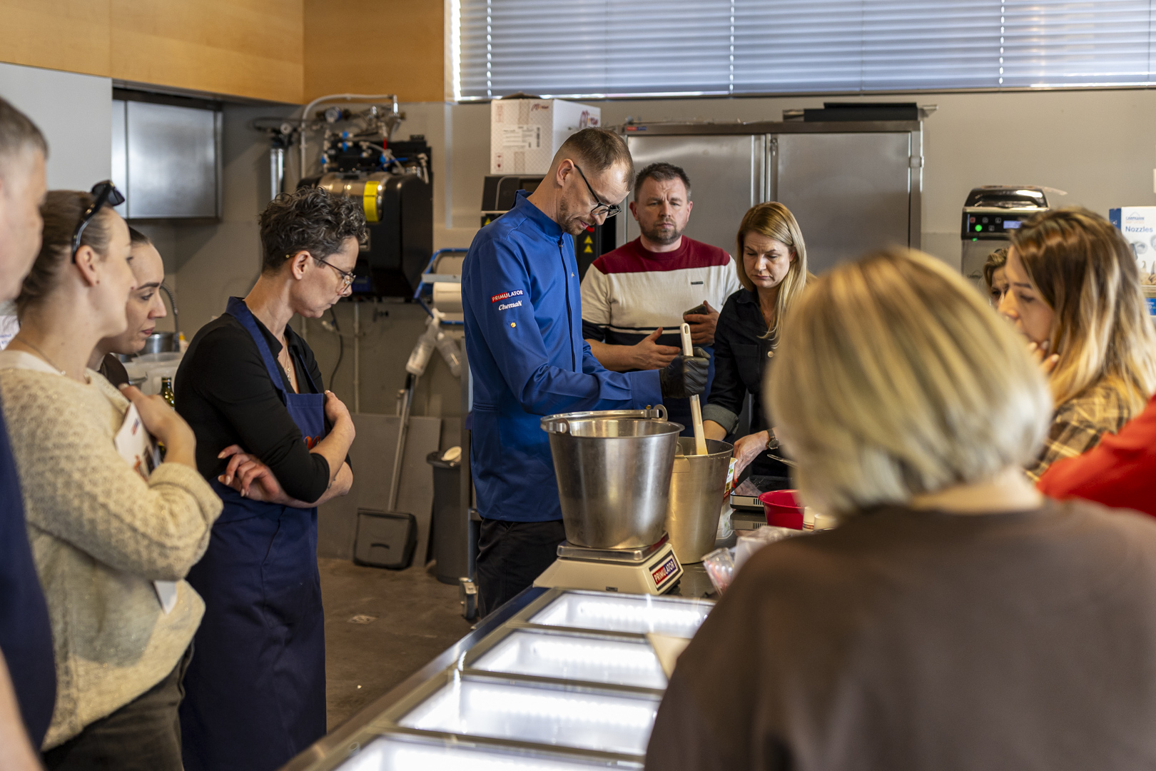 Technolog cukierniczy Marcin Zych prezentuje uczestnikom zasady komponowania i balansowania mieszanki lodowej. Demonstracja obejmuje dobór składników, kontrolę proporcji oraz wpływ receptury na strukturę i jakość lodów rzemieślniczych.